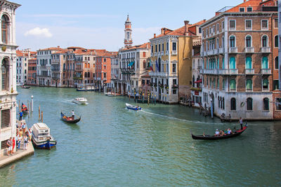 Boats in river with buildings in background