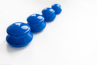 Close-up of blue buttons against white background