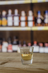 Close-up of scotch in shot glass on bar counter