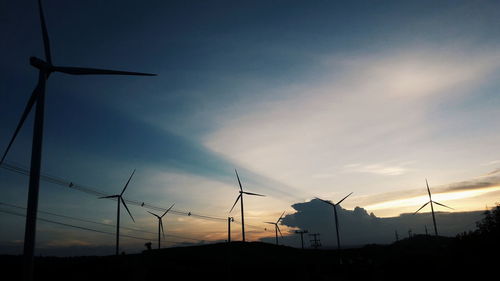 Low angle view of silhouette windmill against sky during sunset