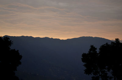 Scenic view of mountains against sky at sunset