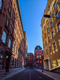 Street amidst buildings against sky