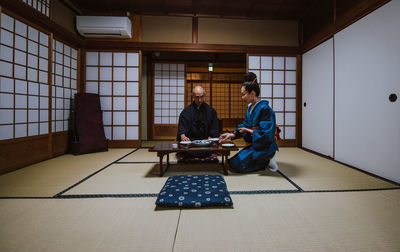 People sitting on floor at home