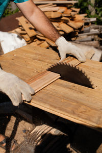 Midsection of man working on table