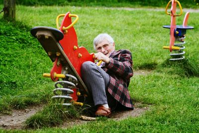 Girl playing on grassy field in park