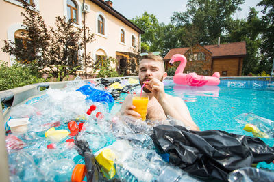 Full length of boy in swimming pool at yard