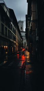 City street amidst buildings during rainy season