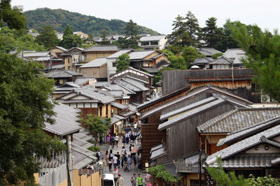Houses and buildings in town against sky