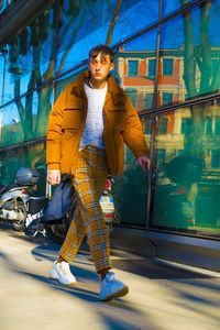 Portrait of young man looking away while standing outdoors