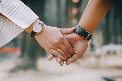 Close-up of couple holding hands