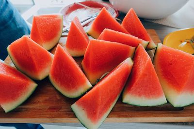 High angle view of watermelon slices on wooden table