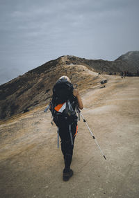 A woman with backpack hike at mount ijen in banyuwangi, east java, indonesia.