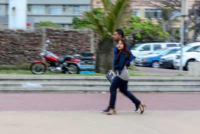 Blurred motion of man on road in city