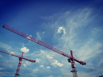 Low angle view of crane against sky