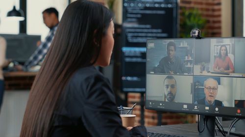 Computer programmer talking on video conference