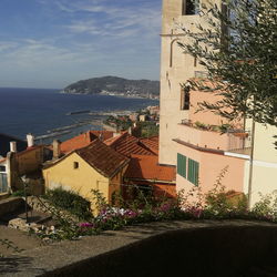 High angle view of buildings by sea against sky