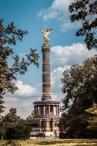 Low angle view of statue against cloudy sky