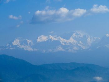 Scenic view of mountains against blue sky