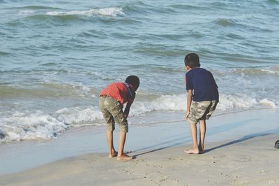 Rear view of man and woman on beach