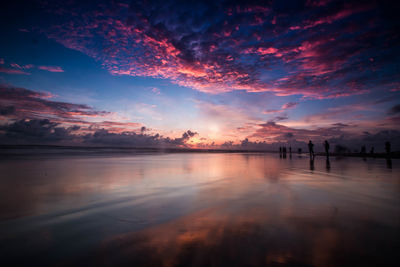 Scenic view of lake against romantic sky at sunset