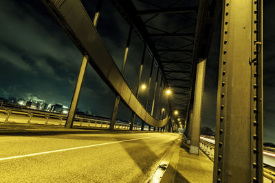 Illuminated bridge against sky at night