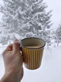 Person holding coffee cup