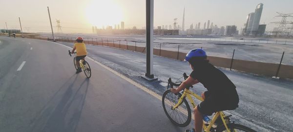 Low section of man riding bicycle on street