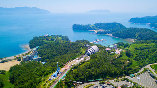 High angle view of trees and bay against sky