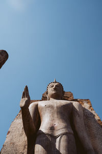 Low angle view of statue against clear blue sky