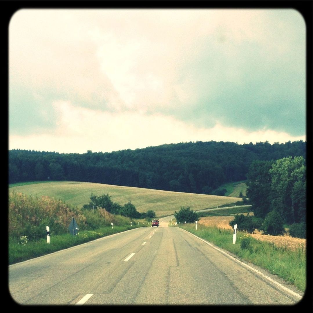 transportation, road, the way forward, transfer print, sky, country road, road marking, landscape, diminishing perspective, cloud - sky, auto post production filter, vanishing point, field, car, grass, tree, cloud, cloudy, tranquil scene, nature