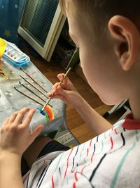 High angle view of boy painting at home