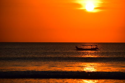Scenic view of sea against orange sky