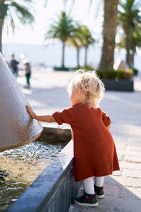 Rear view of woman standing in water