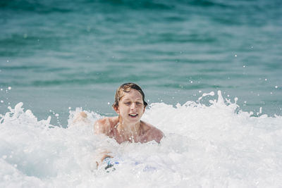 Young man swimming in sea