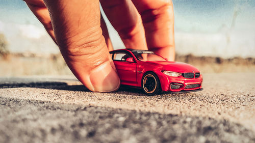 Midsection of man holding toy car