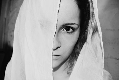 Close-up portrait of woman covering face