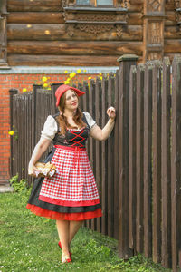 Full length of young woman standing on field