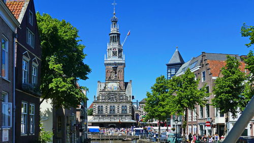 Panoramic view of buildings and trees against clear blue sky