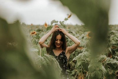 Young woman standing at sunflower farm