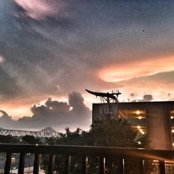 Silhouette of built structure against sunset sky