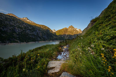 Scenic view of lake and mountains against clear sky