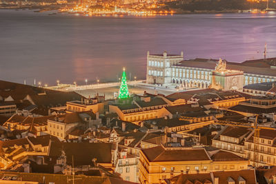 High angle view of buildings in city at night