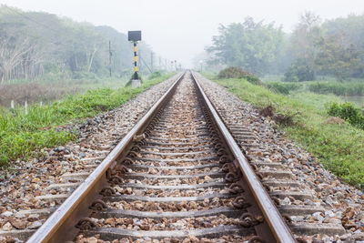 View of railroad tracks in foggy weather