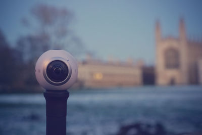 Close-up of coin-operated binoculars against sky