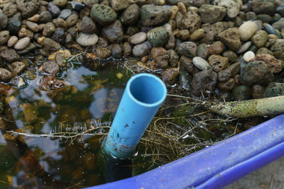 High angle view of blue container on field