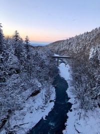 Snow covered arch bridge against sky during winter