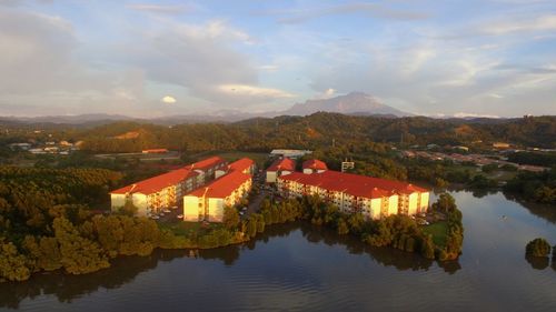 Scenic view of lake by buildings against sky