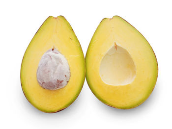 Close-up of yellow fruits against white background