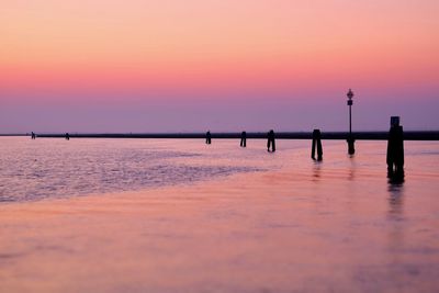 Scenic view of sea against orange sky