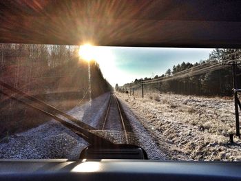 Road passing through sunset